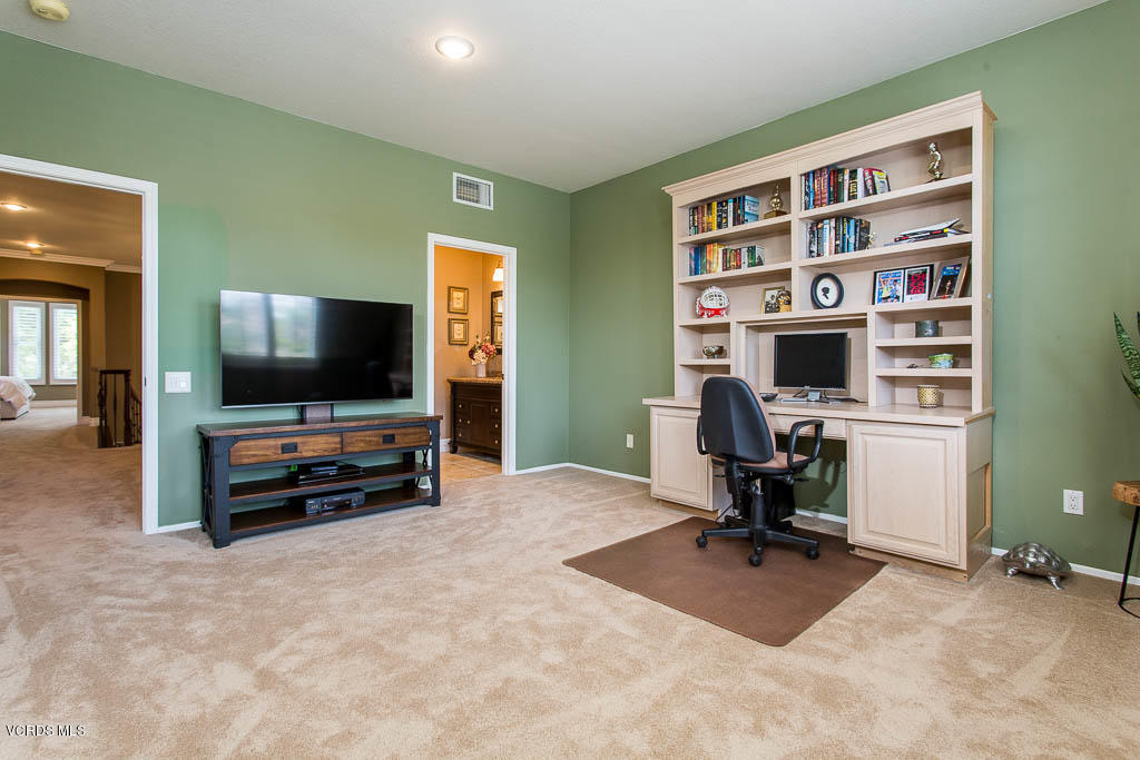 11245 Bentcreek Road Moorpark, CA 93021 - Photo 36 of 48 a view of a livingroom with workspace and a flat screen tv