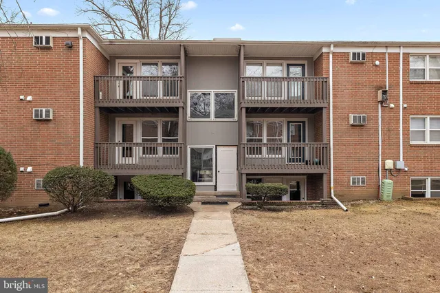 a front view of a house with garden and plants