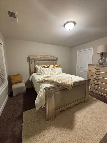 a bedroom with a bed and a couch