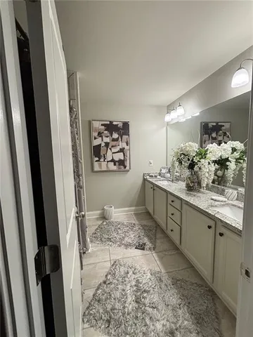 a bathroom with a double vanity sink and a mirror