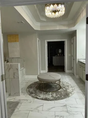 a view of a hallway with a chandelier