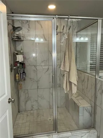 a bathroom with a glass shower door