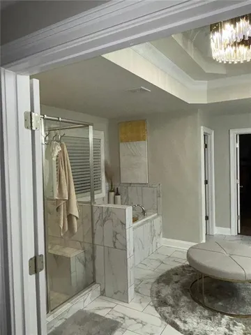 a spacious bathroom with a granite countertop sink a toilet a mirror and shower