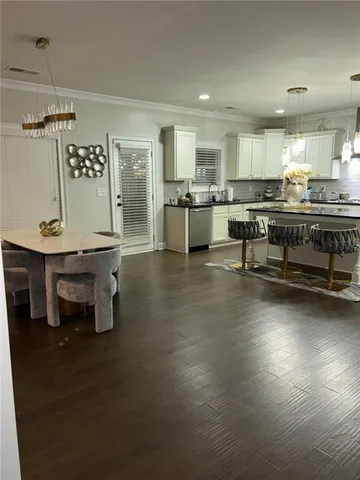 a kitchen with stainless steel appliances kitchen island granite countertop a sink and cabinets