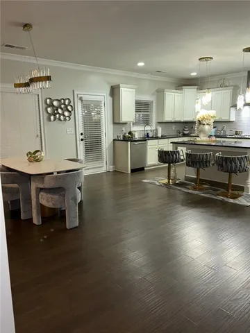 a kitchen with stainless steel appliances kitchen island granite countertop a sink and cabinets