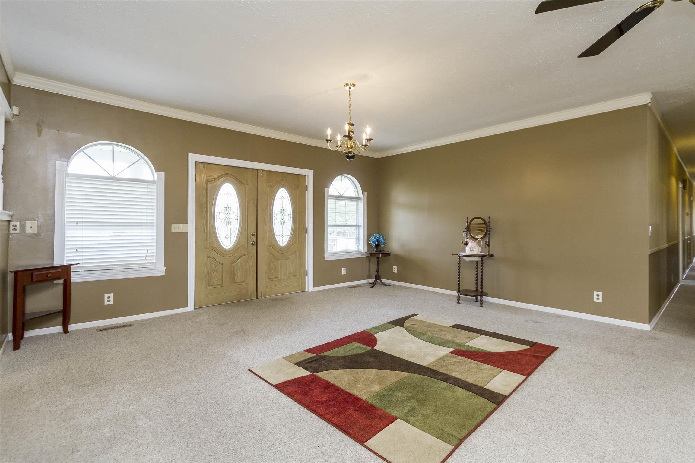 5067 Youngville Road Springfield, TN 37172 - Photo 11 of 28 a spacious bedroom with a bed and a chandelier