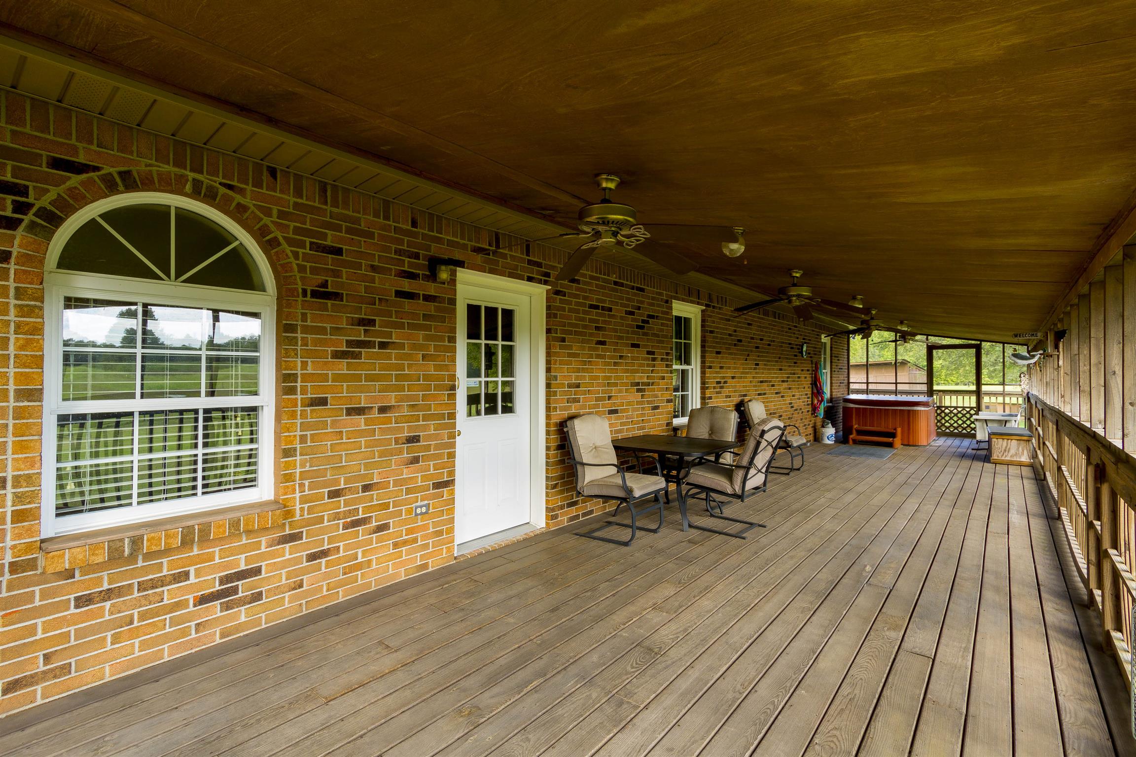 5067 Youngville Road Springfield, TN 37172 - Photo 19 of 28 a view of a patio with table and chairs with wooden floor and fence