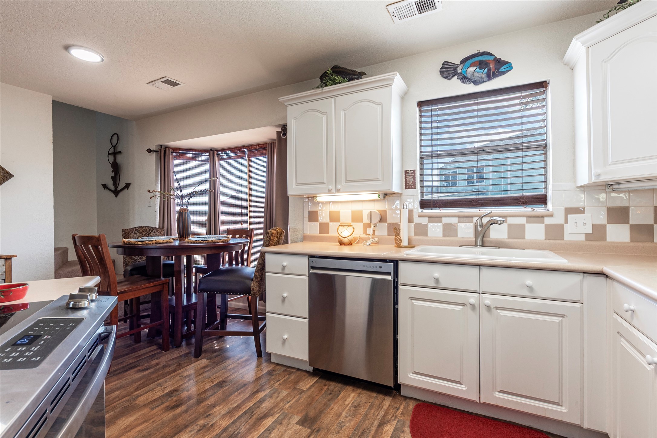 3 Pelican La Marque, TX 77568 - Photo 11 of 46 a kitchen with granite countertop a sink cabinets and dining table