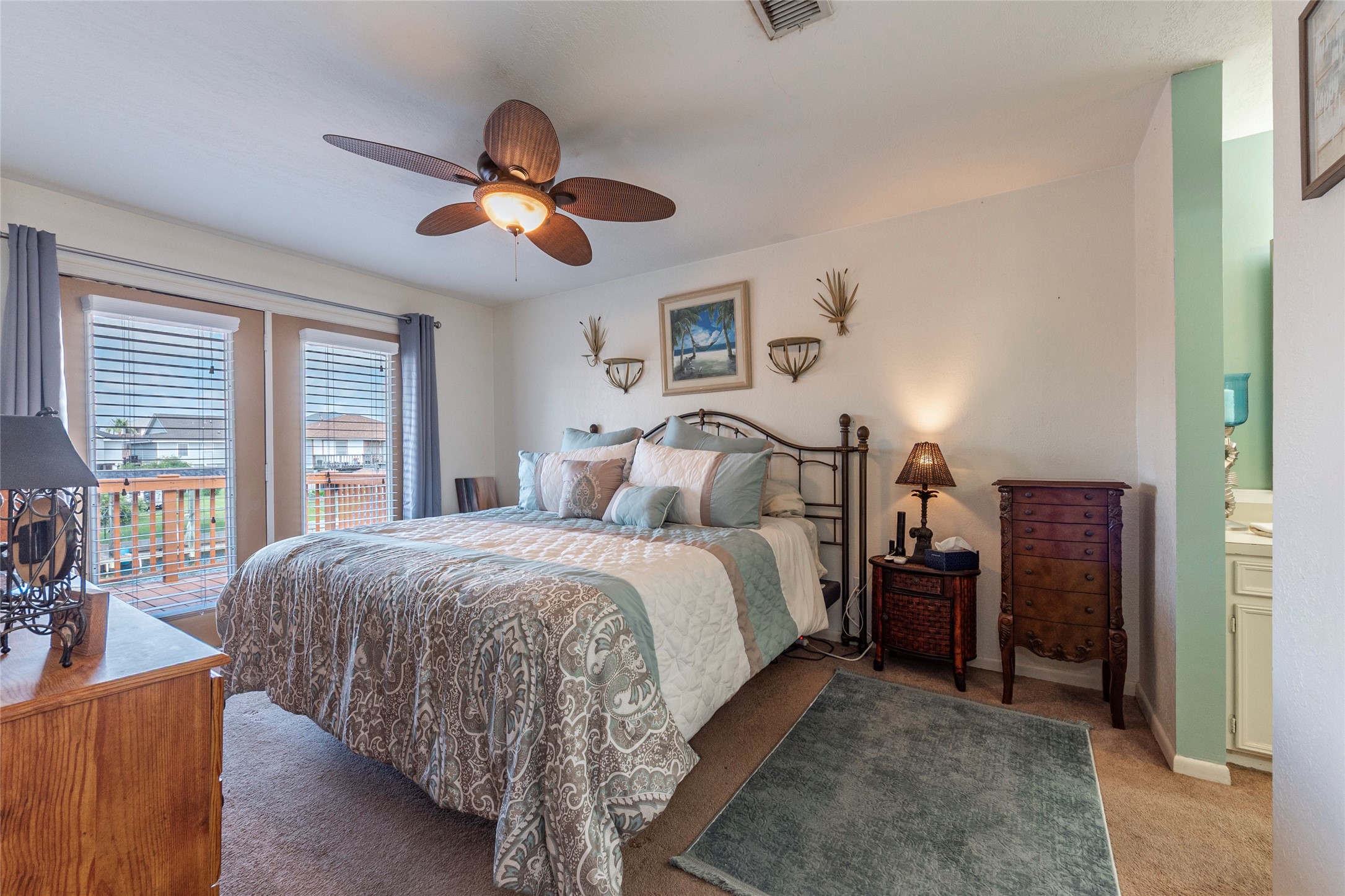 3 Pelican La Marque, TX 77568 - Photo 13 of 46 a spacious bedroom with a large bed and a chandelier