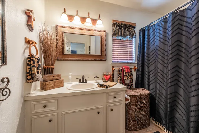 a bedroom with a bed and a flat tv screen on the dresser