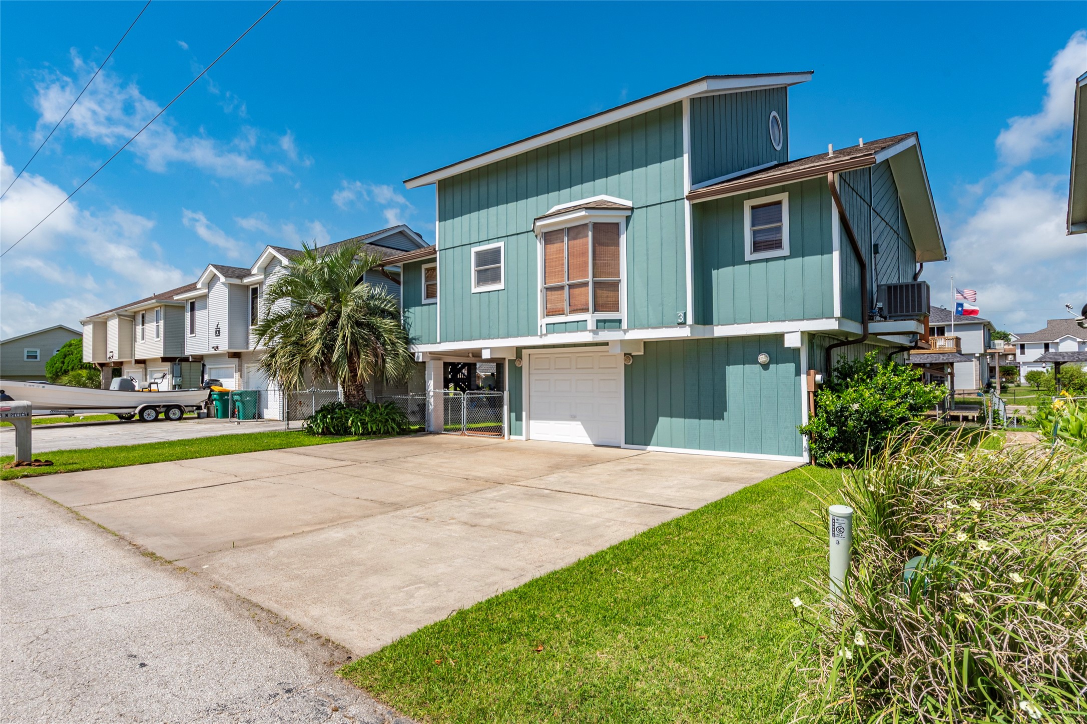 3 Pelican La Marque, TX 77568 - Photo 20 of 46 a front view of a house with a yard and garage