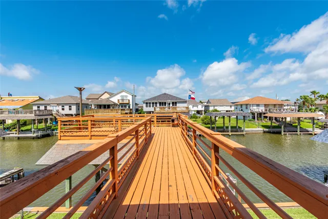 a view of a lake with a house swimming pool and outdoor seating
