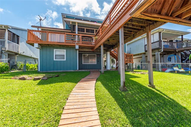 a view of a lake and a house with swimming pool table and chairs