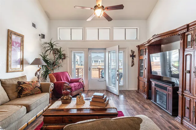 a living room with furniture ceiling fan and a rug