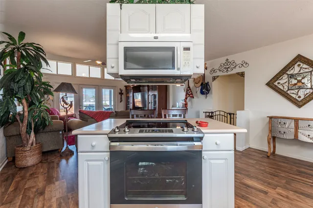 a spacious bedroom with a large bed and a chandelier