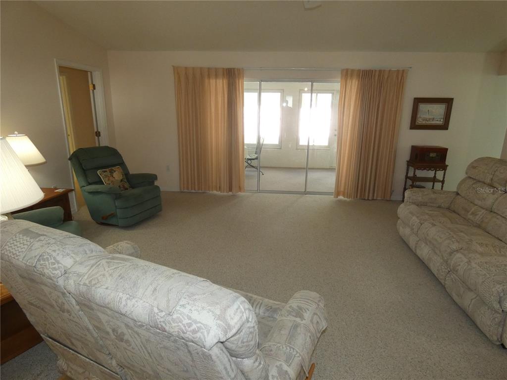 8365 Boyce Street Spring Hill, FL 34606 - Photo 14 of 38 a living room with furniture and a flat screen tv