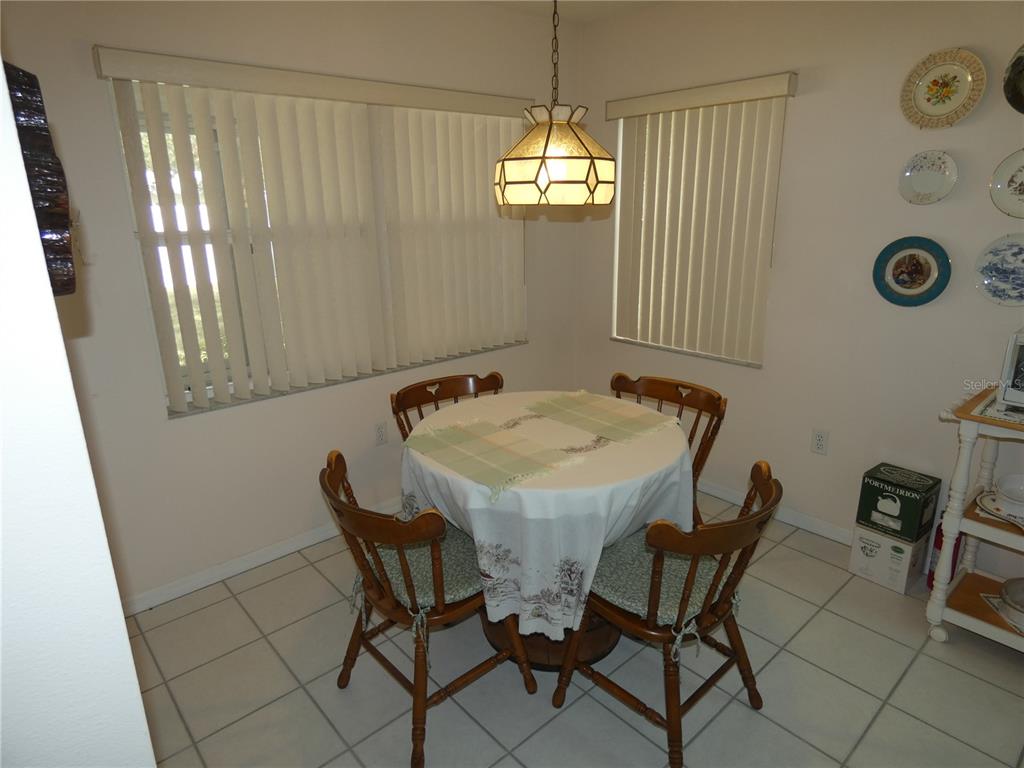 8365 Boyce Street Spring Hill, FL 34606 - Photo 19 of 38 a view of a dining room with furniture and a chandelier