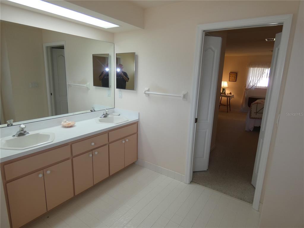 8365 Boyce Street Spring Hill, FL 34606 - Photo 27 of 38 a spacious bathroom with a double vanity sink and mirror