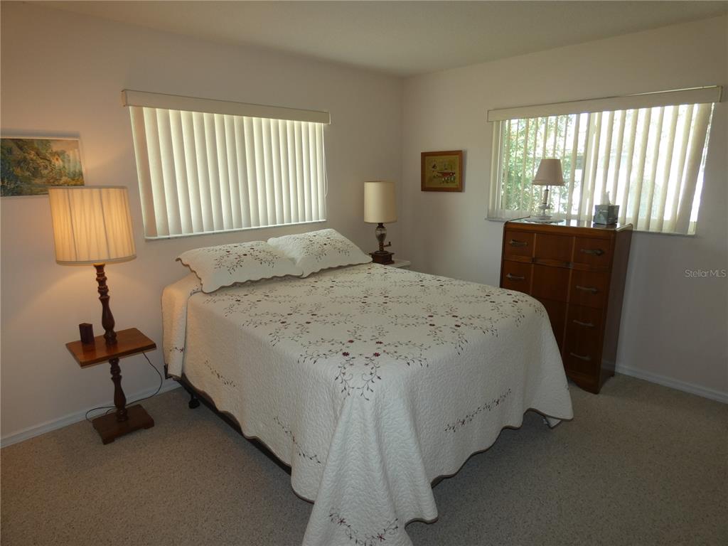 8365 Boyce Street Spring Hill, FL 34606 - Photo 33 of 38 a bedroom with a bed and a lamp
