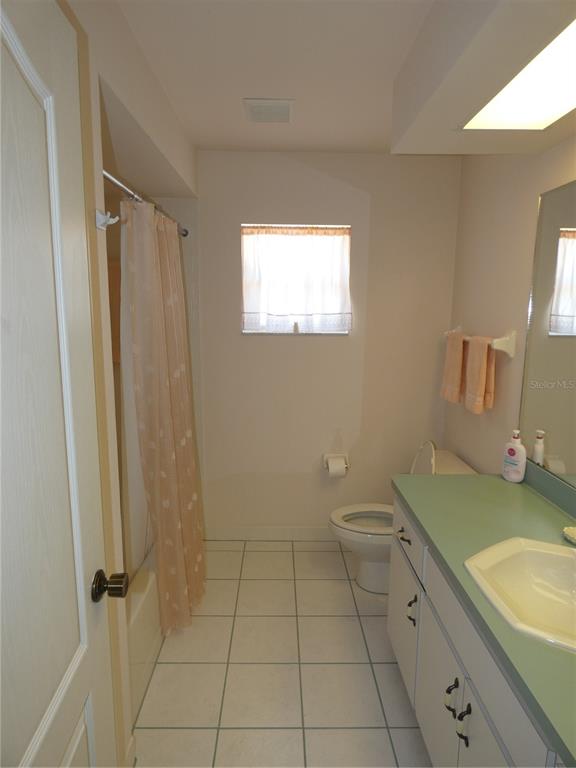 8365 Boyce Street Spring Hill, FL 34606 - Photo 36 of 38 a bathroom with a granite countertop sink toilet and shower