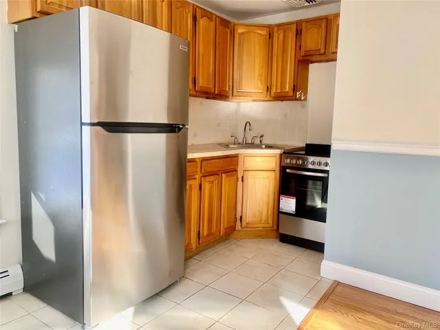 a kitchen with stainless steel appliances granite countertop a refrigerator and a stove