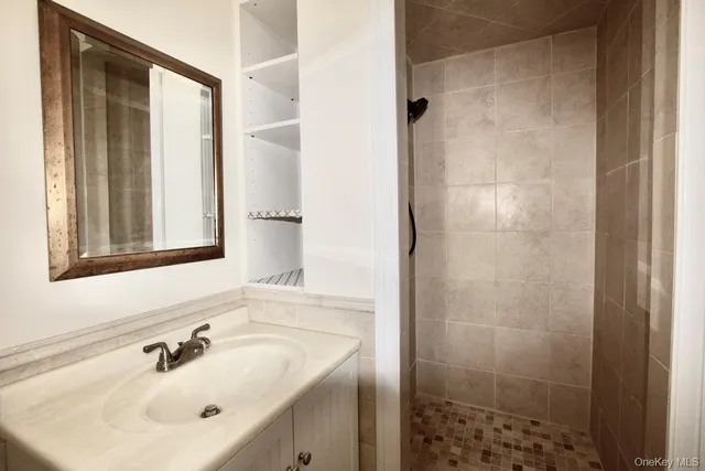 a bathroom with a shower and a sink