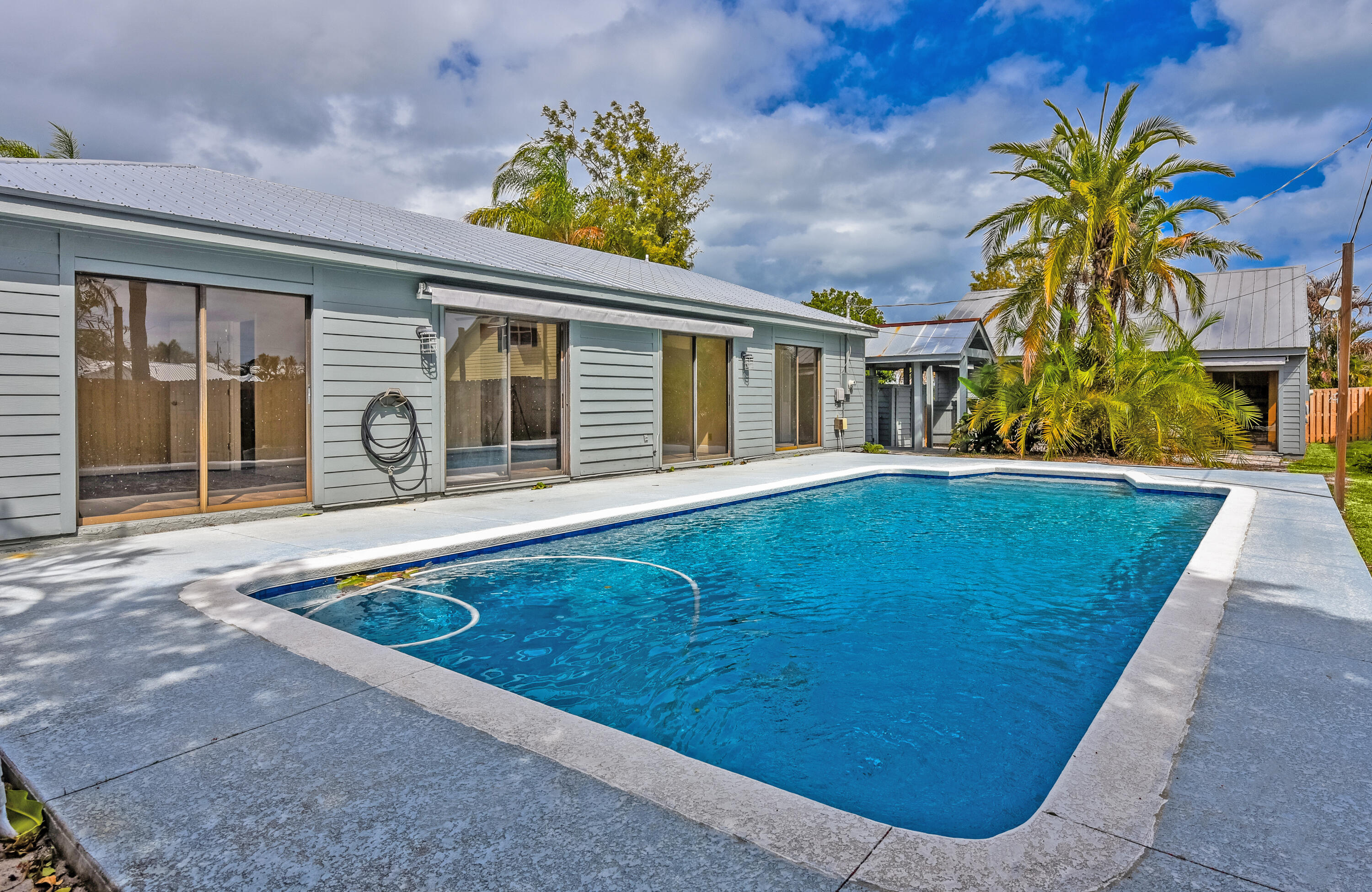5666 Southeast Matousek Street Stuart, FL 34997 - Photo 1 of 49 a front view of a house with a yard