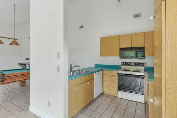 a kitchen with a stove top oven and sink