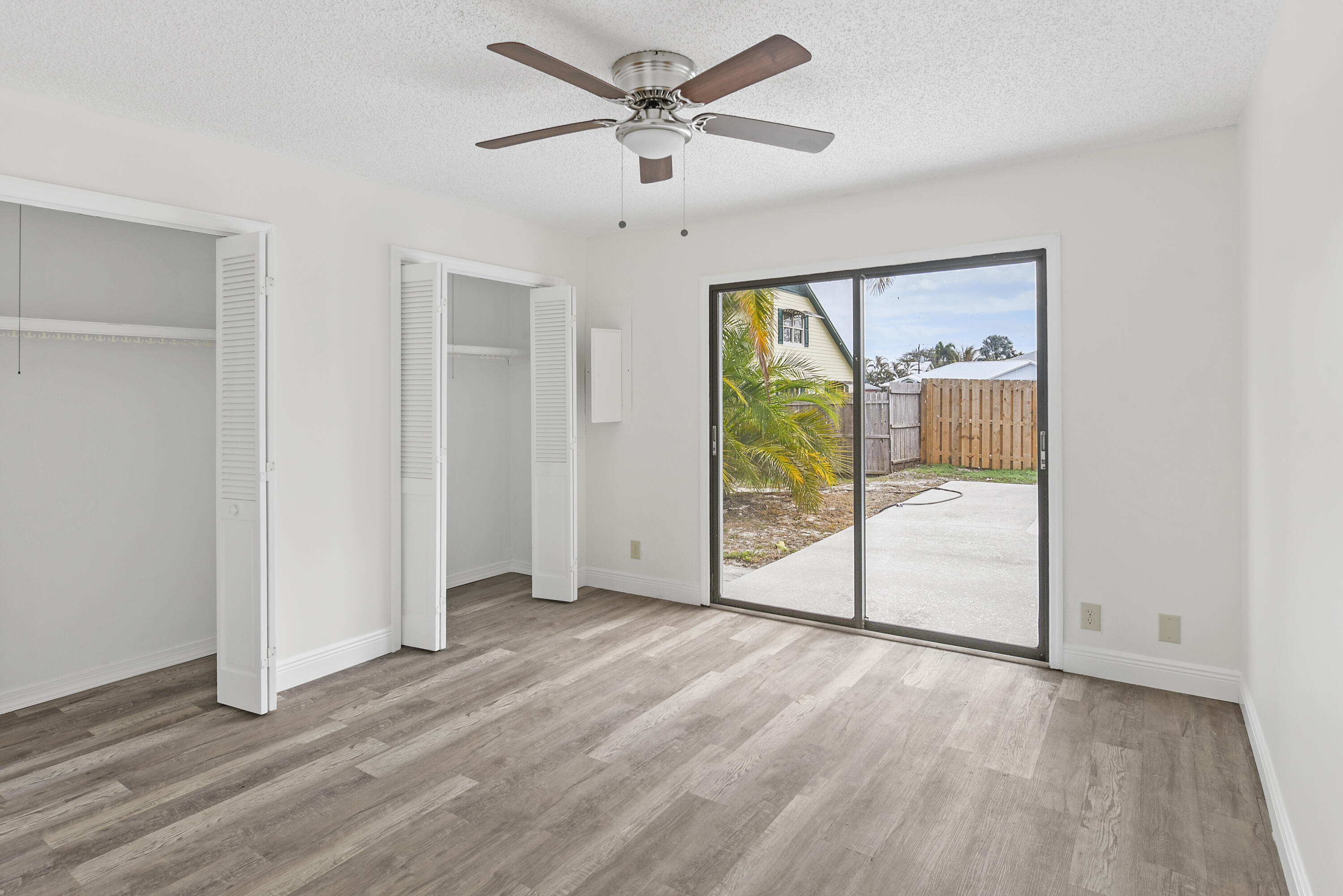 5666 Southeast Matousek Street Stuart, FL 34997 - Photo 12 of 49 a view of a livingroom with a ceiling fan and window