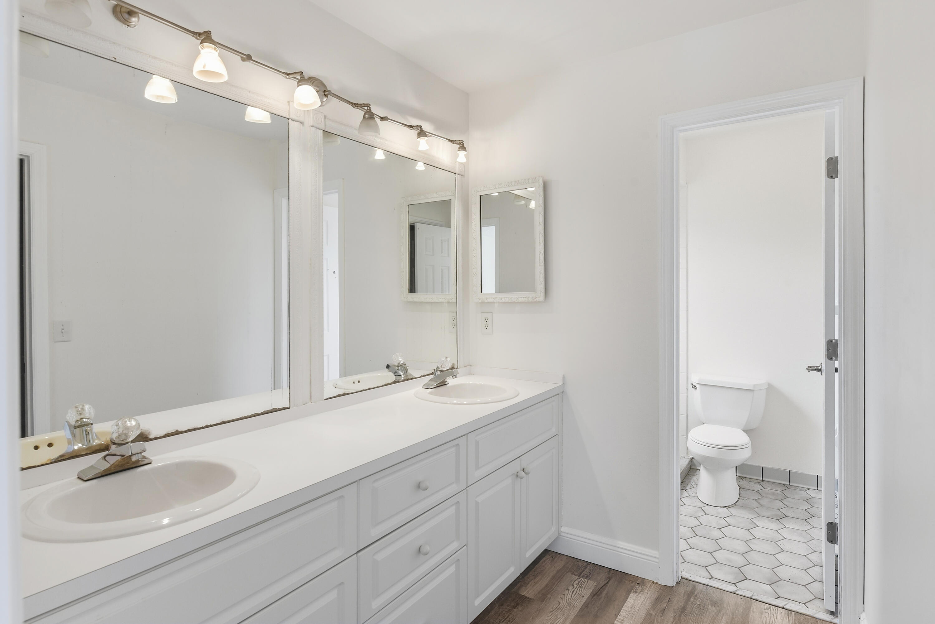 5666 Southeast Matousek Street Stuart, FL 34997 - Photo 17 of 49 a bathroom with a double vanity sink toilet and shower