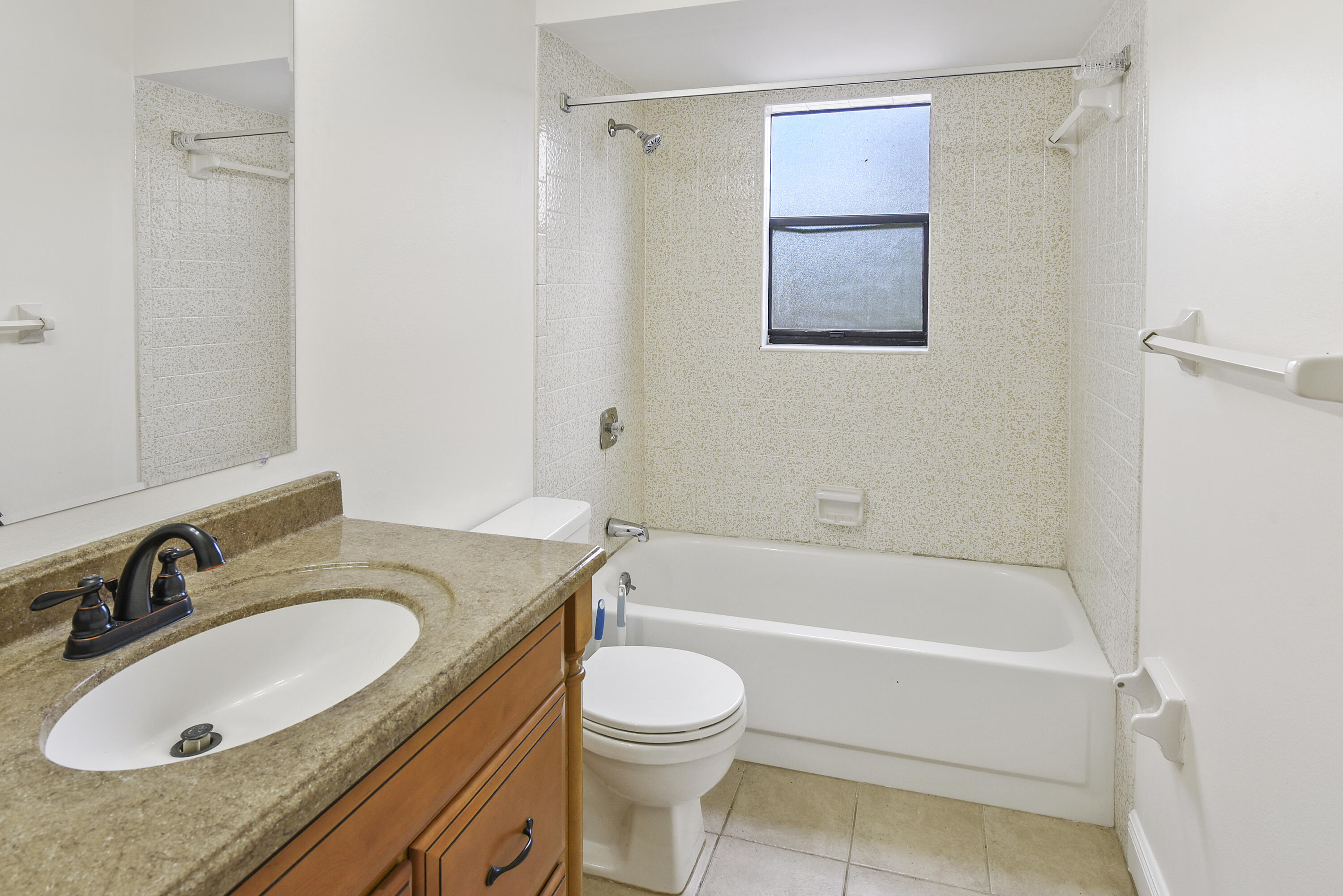 5666 Southeast Matousek Street Stuart, FL 34997 - Photo 18 of 49 a bathroom with a granite countertop sink toilet and shower