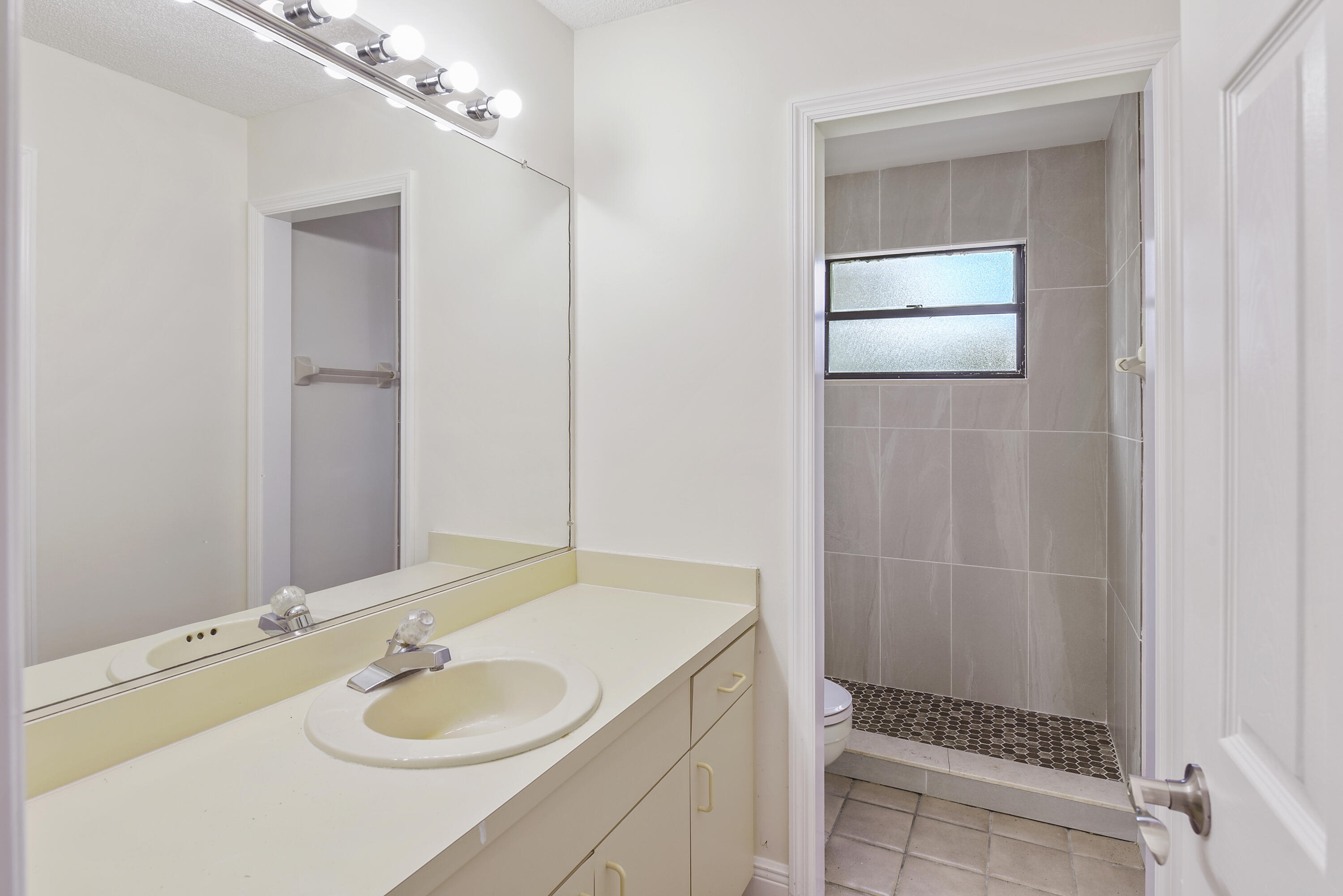 5666 Southeast Matousek Street Stuart, FL 34997 - Photo 20 of 49 a bathroom with a granite countertop sink toilet and shower