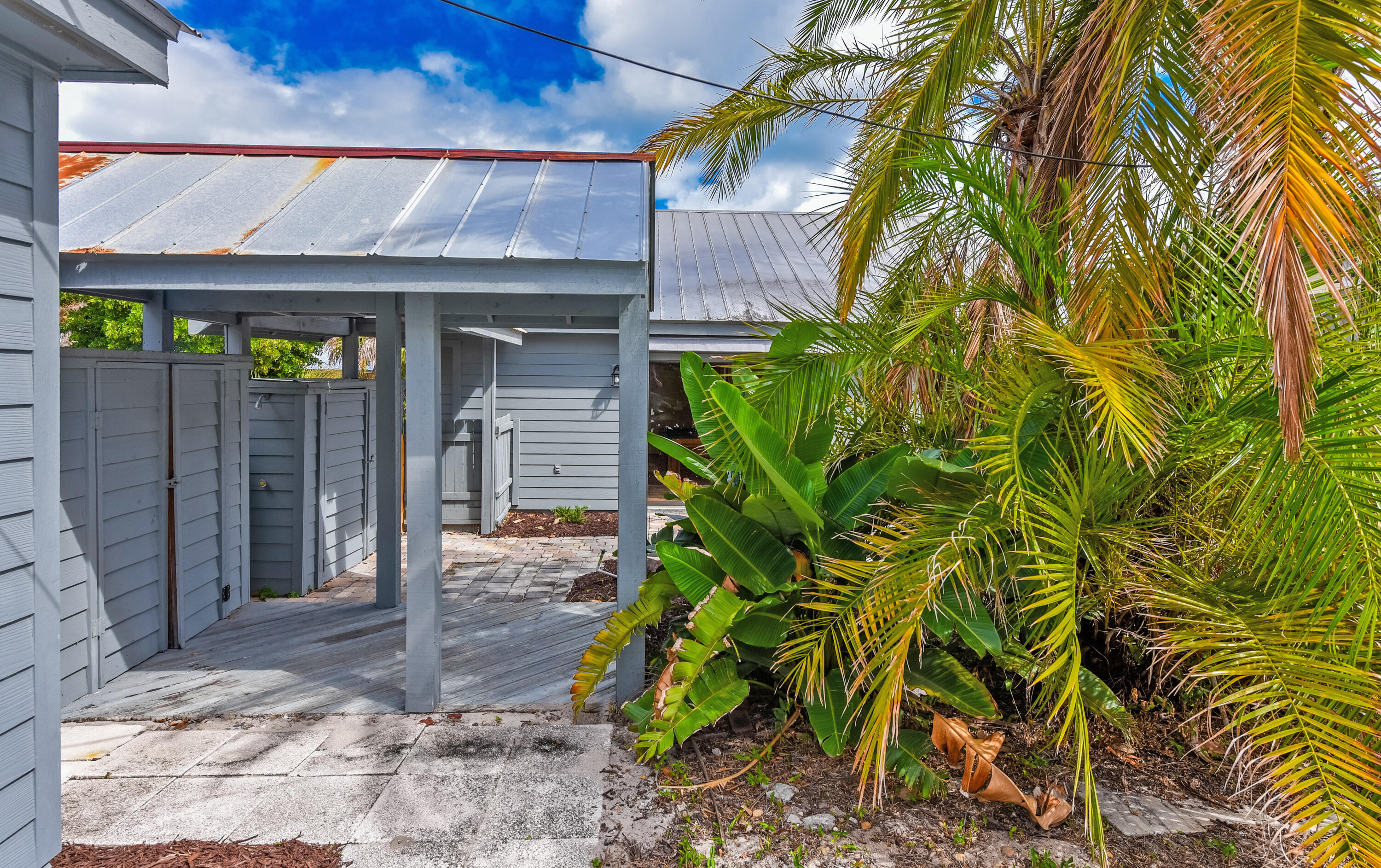 5666 Southeast Matousek Street Stuart, FL 34997 - Photo 29 of 49 a front view of a house with a yard and garage