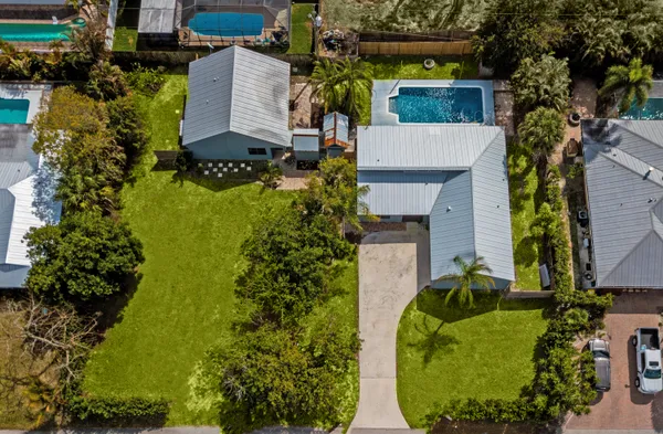 an aerial view of a house with a yard and garden