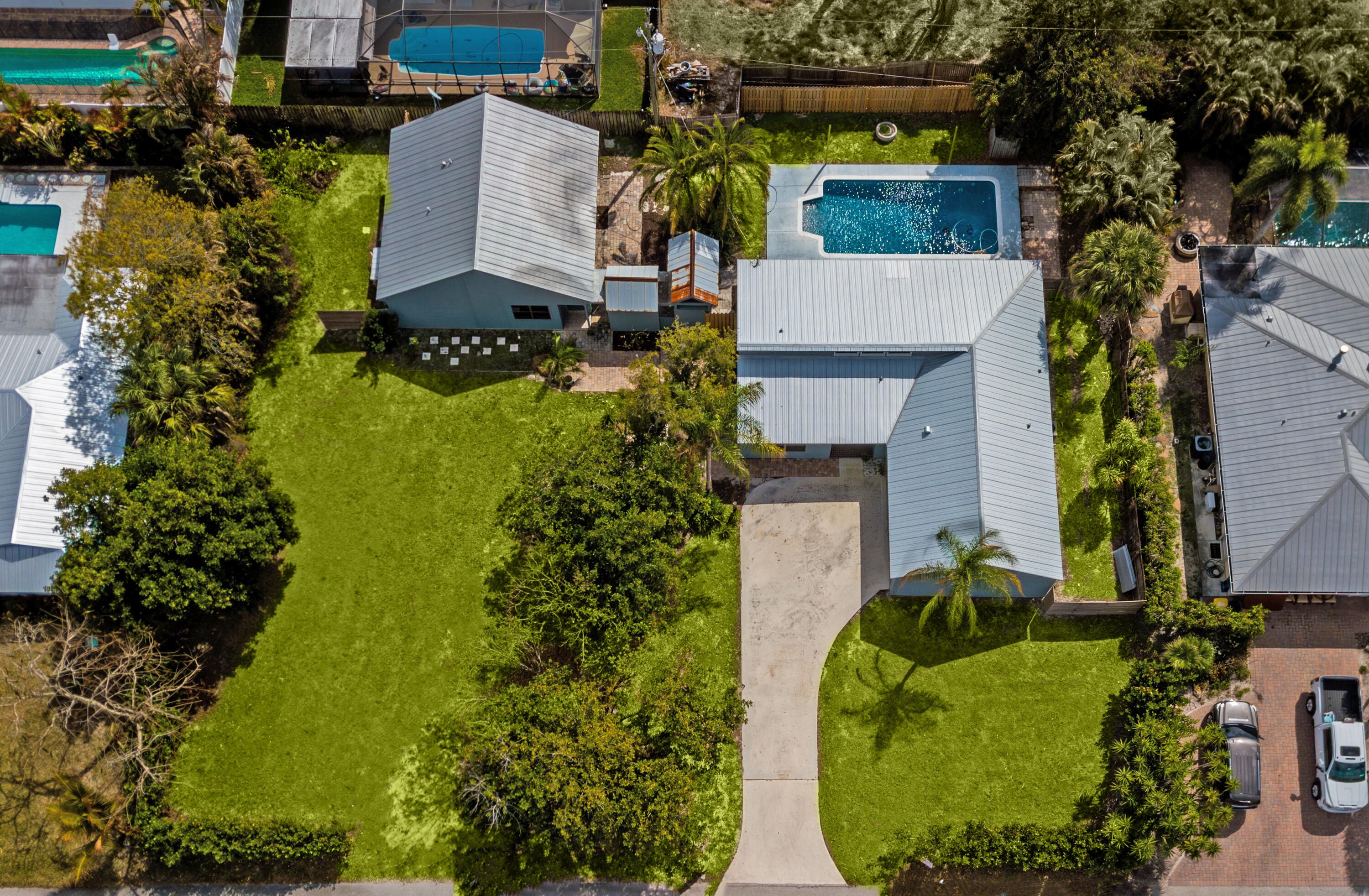 5666 Southeast Matousek Street Stuart, FL 34997 - Photo 3 of 49 an aerial view of a house with a yard and garden