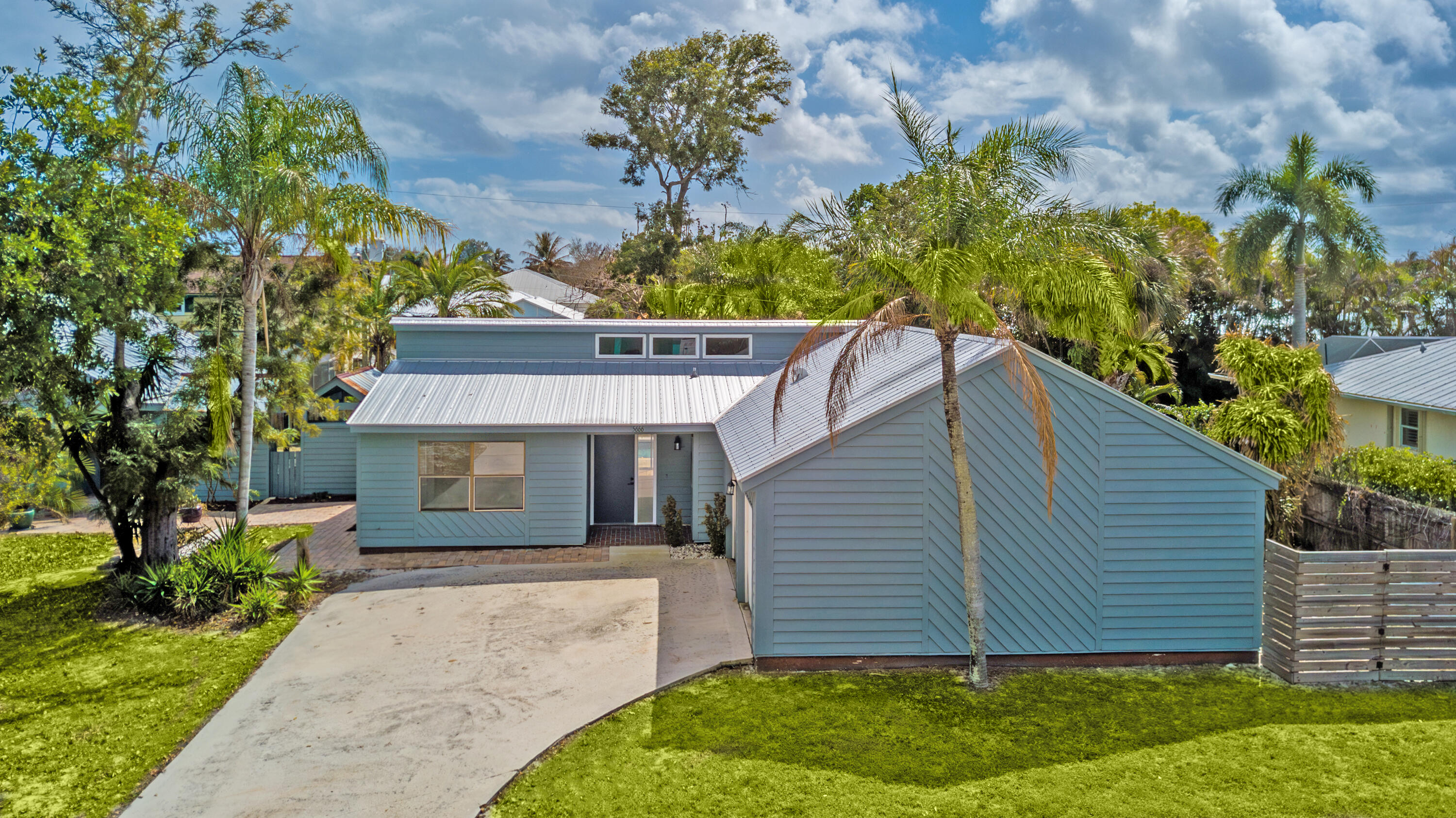 5666 Southeast Matousek Street Stuart, FL 34997 - Photo 31 of 49 a house view with a garden space