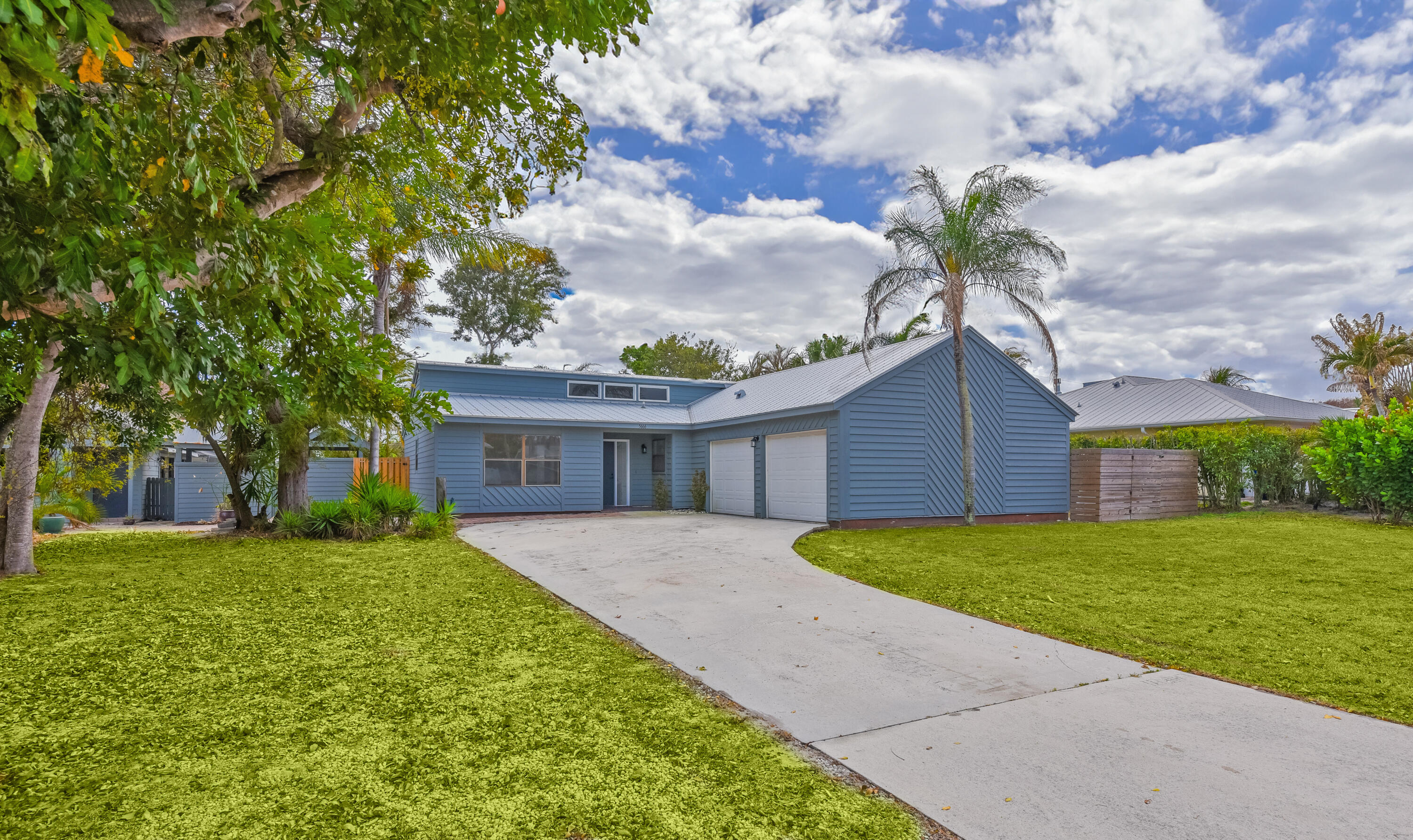 5666 Southeast Matousek Street Stuart, FL 34997 - Photo 33 of 49 a view of a house with a yard