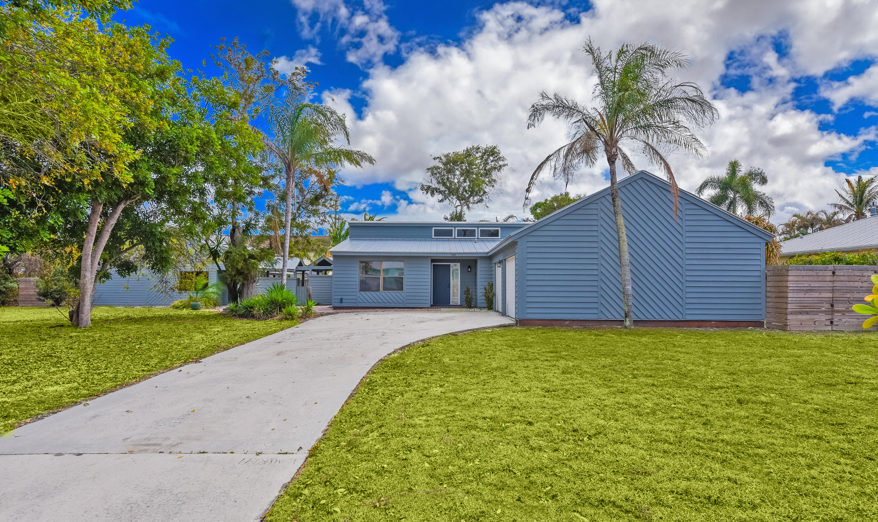 5666 Southeast Matousek Street Stuart, FL 34997 - Photo 34 of 49 a view of a house with a yard and potted plants