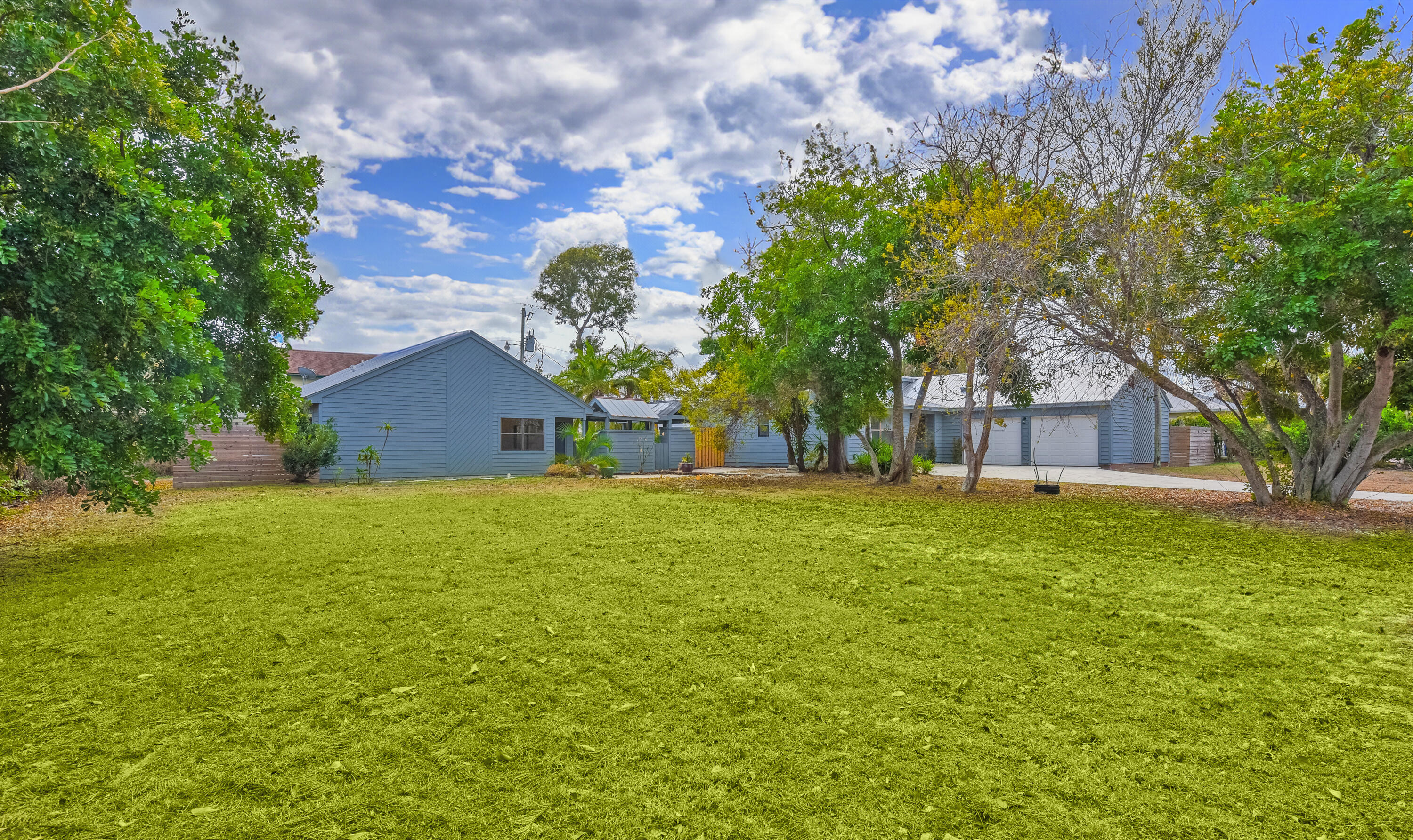 5666 Southeast Matousek Street Stuart, FL 34997 - Photo 35 of 49 a view of a house with a yard