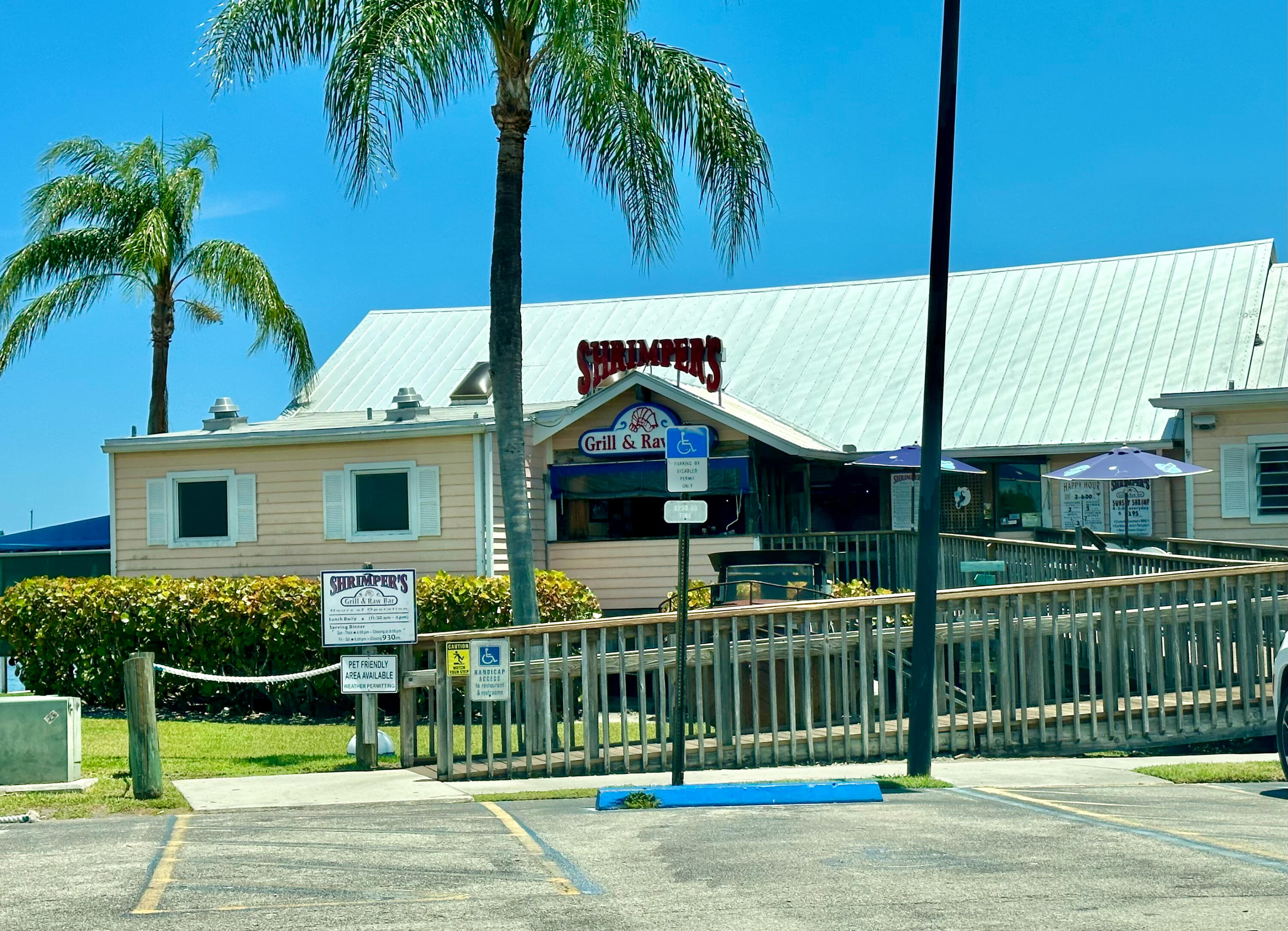 5666 Southeast Matousek Street Stuart, FL 34997 - Photo 42 of 49 a front view of a house with a garden and plants