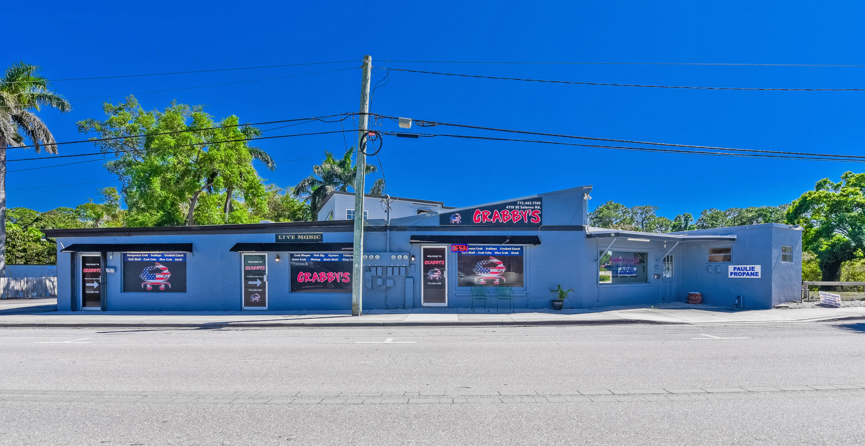 5666 Southeast Matousek Street Stuart, FL 34997 - Photo 45 of 49 front view of a house with a street