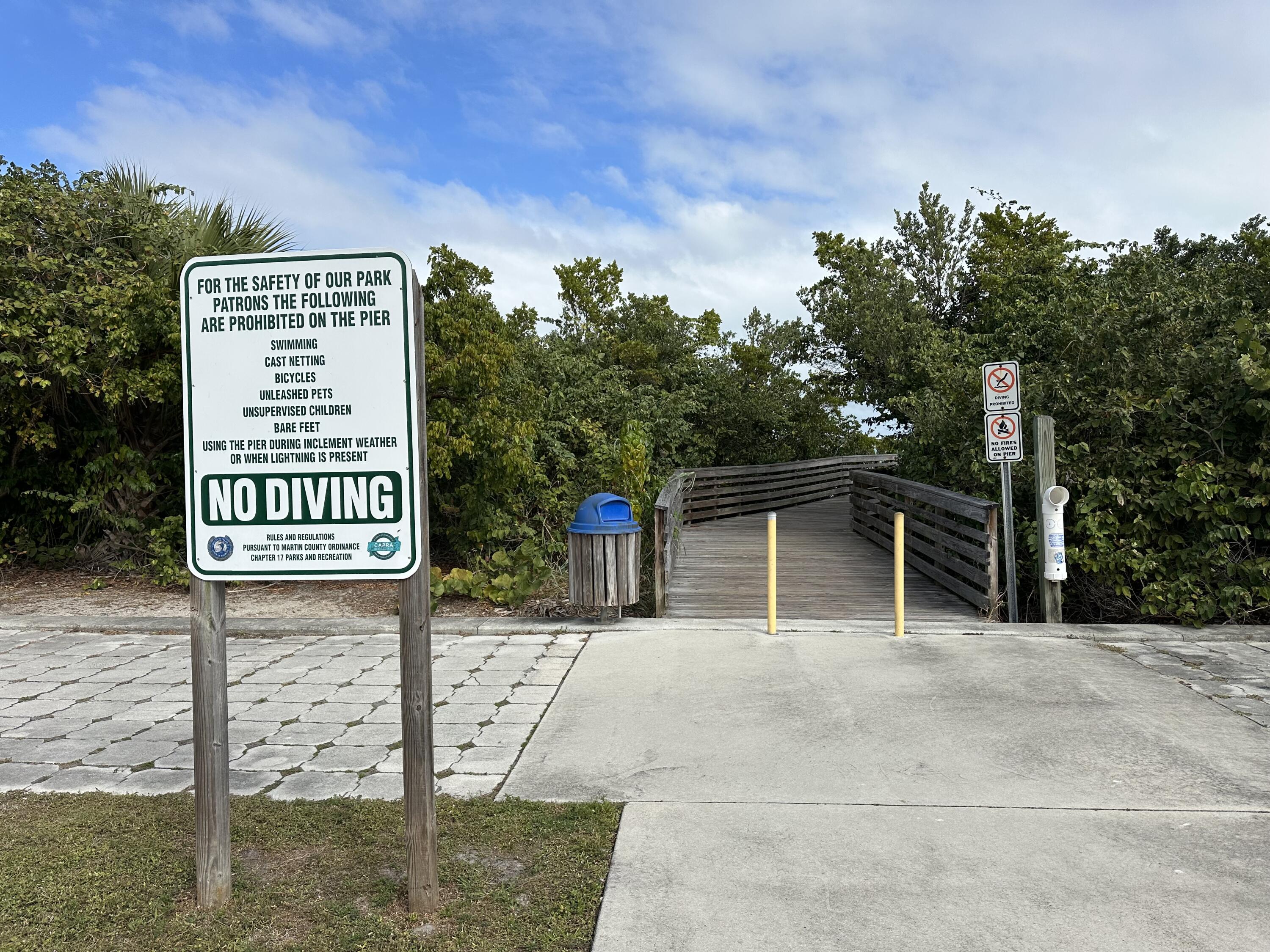 5666 Southeast Matousek Street Stuart, FL 34997 - Photo 49 of 49 a view of a street with potted plants