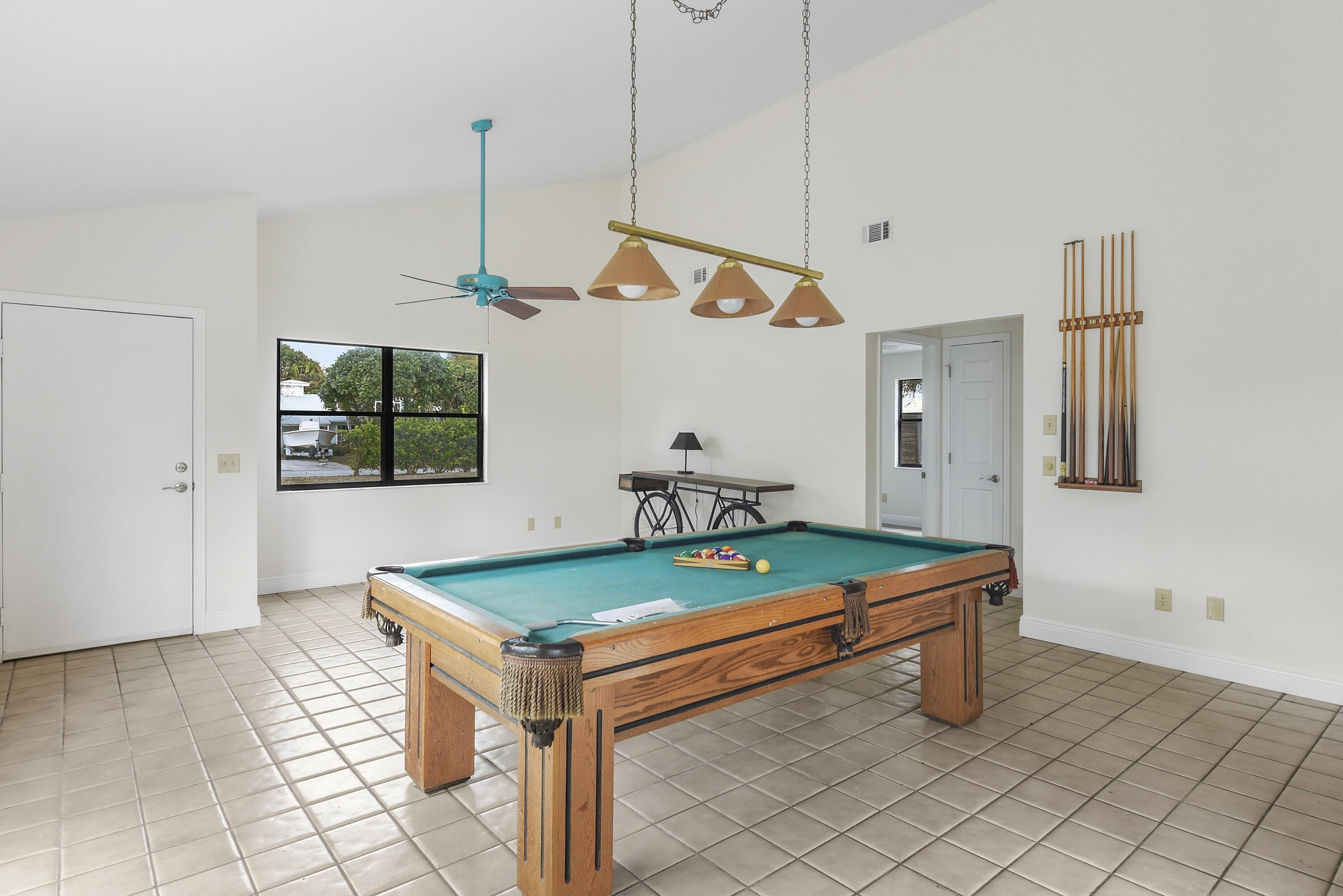 5666 Southeast Matousek Street Stuart, FL 34997 - Photo 9 of 49 a room with pool table and windows