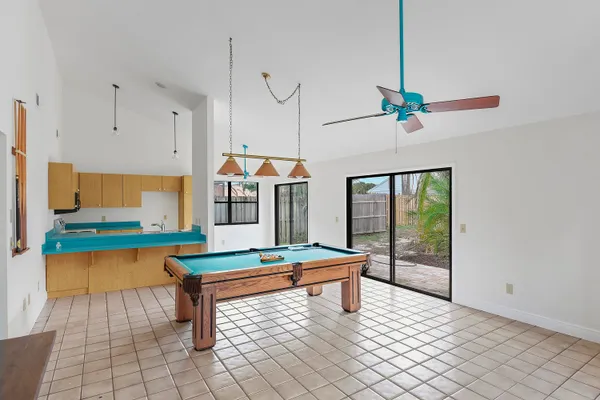a room with pool table and windows