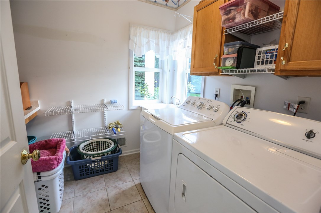 83 Angels Path Penfield, NY 14580 - Photo 32 of 36 Tiled laundry room with sink, folding table washer