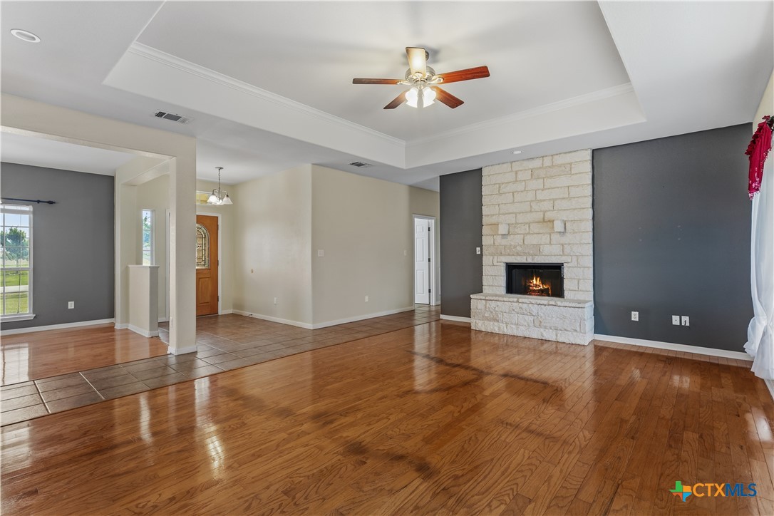 283 County Road 4710 Kempner, TX 76539 - Photo 9 of 47 an empty room with wooden floor and fireplace