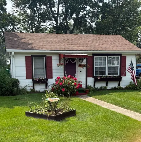 a front view of a house with a garden and porch