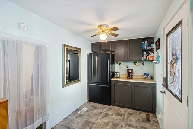 a kitchen with stainless steel appliances granite countertop a refrigerator a stove top oven a sink and dishwasher