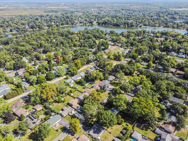 an aerial view of a houses with a yard
