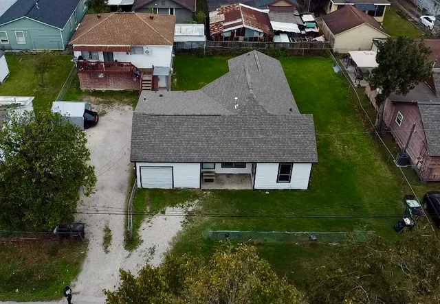 an aerial view of a house with a yard